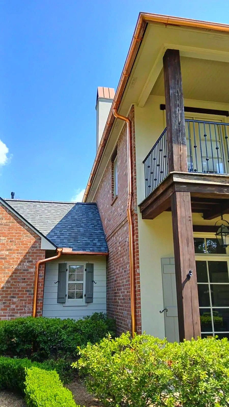 Two-story Louisiana home with a balcony, brick and siding