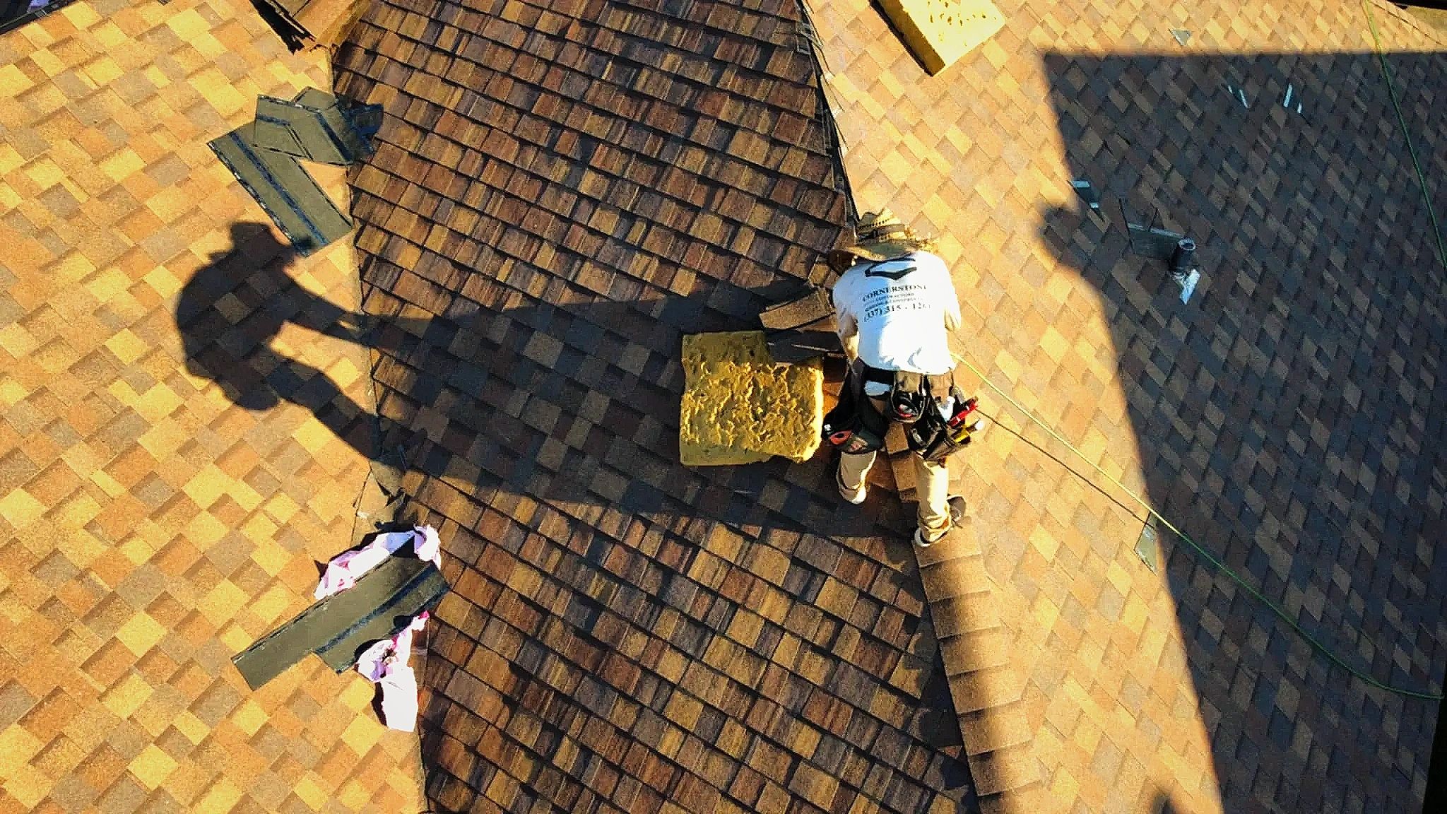 Aerial view of a Cornerstone roofer standing on a freshly shingled roof